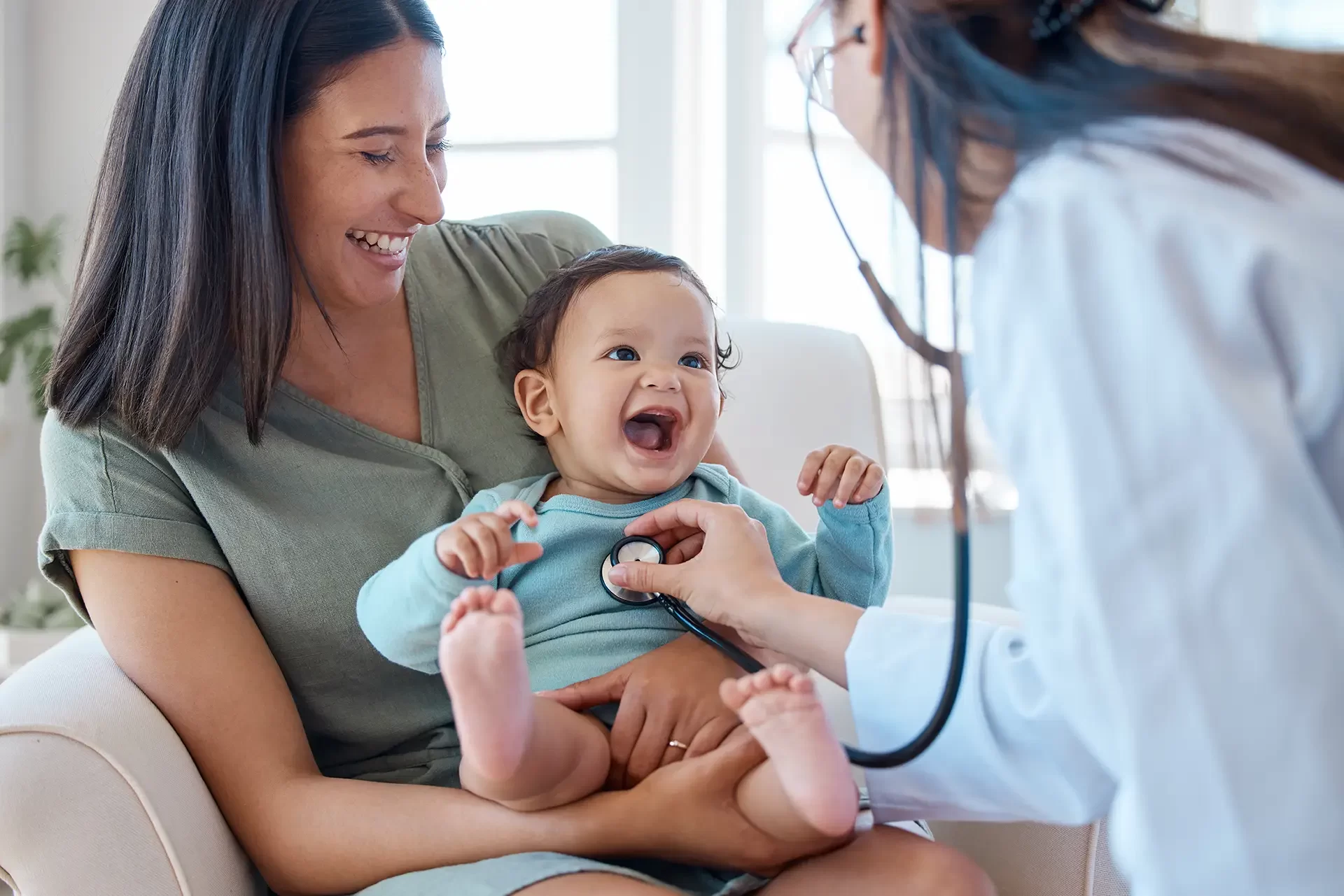 woman doctor listening to a babys heartbeat